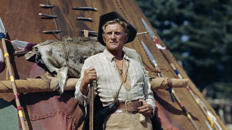 Jim Deakins wearing a white shirt and hat in The Big Sky