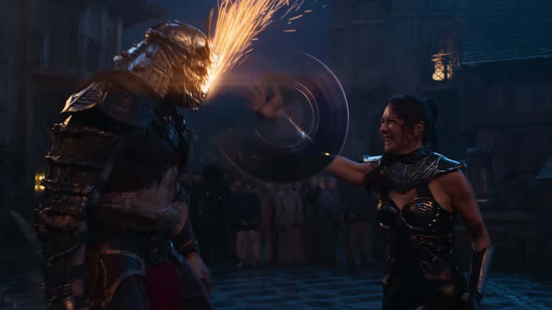 Kitana using her steel fan on Shao Kahn's helmet in Mortal Kombat II