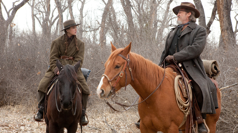 Mattie and Rooster on horseback in True Grit (2010)
