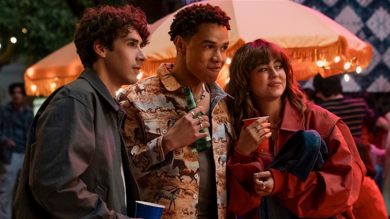 Sean, Dexter, and Allie huddled together outside at a party on Off Campus