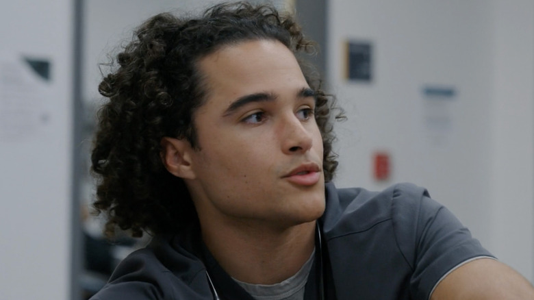 Mateo in his scrubs looking to his left in The Pitt (2025)