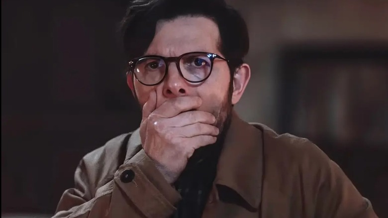 Ohm Bauman covers his mouth in Hokum