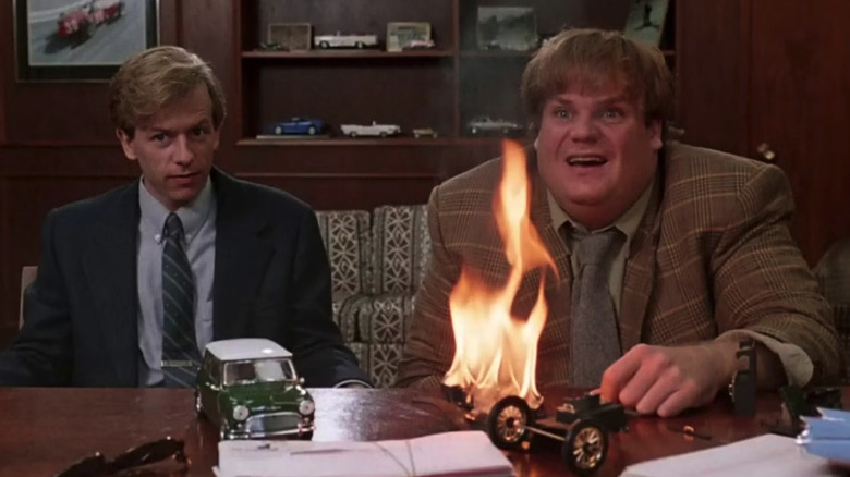 Tommy and Richard try to pitch a sale while a model car burns on the desk in Tommy Boy