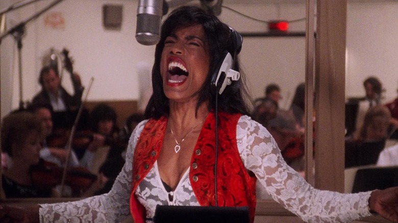 Tina passionately sings into a hanging microphone in What's Love Got to Do with It (1993)