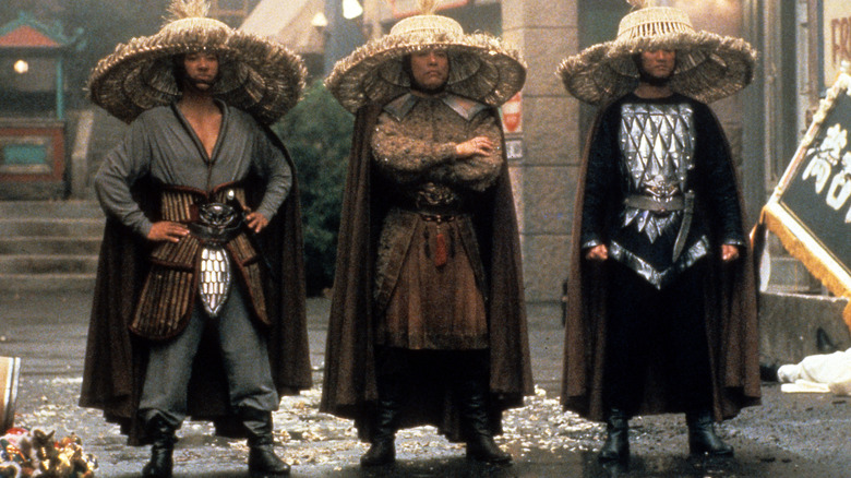 Three men standing in large wicker hats in Big Trouble in Little China (1986)