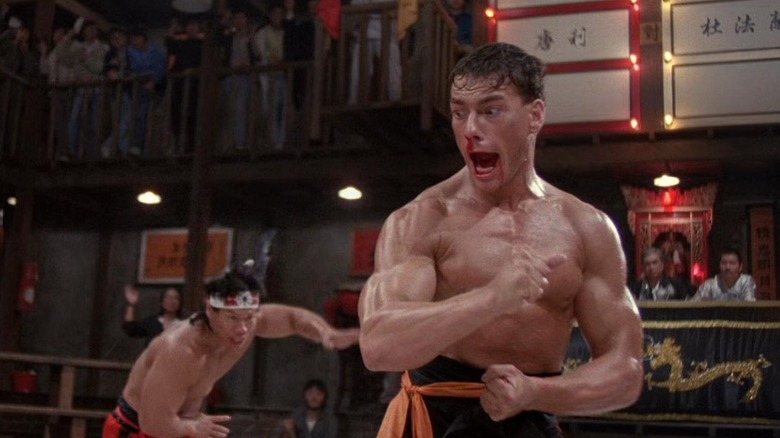 Frank flexes as he looks back at Li in Bloodsport (1988)