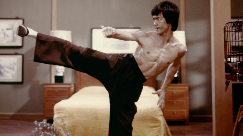 Lee kicking near a bed in Enter the Dragon (1973)