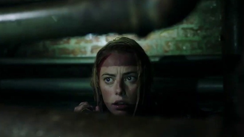 Haley treading water near a pipe in Crawl (2019)