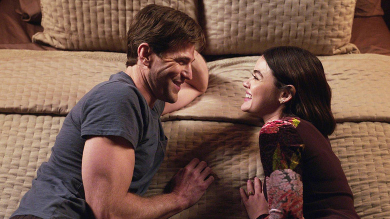 Lucy and Josh grin at each other in "The Hating Game"