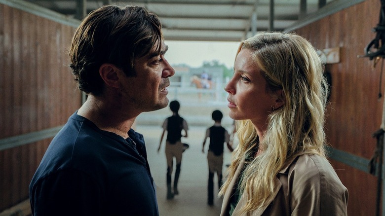 Pietro and Elena look at one another in Vanished into the Night  (2024)