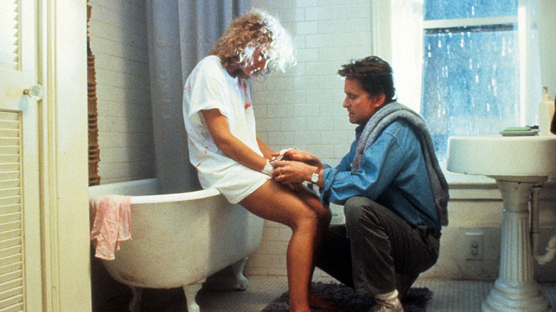 Dan bandaging Alex's wrists in the bathroom in Fatal Attraction