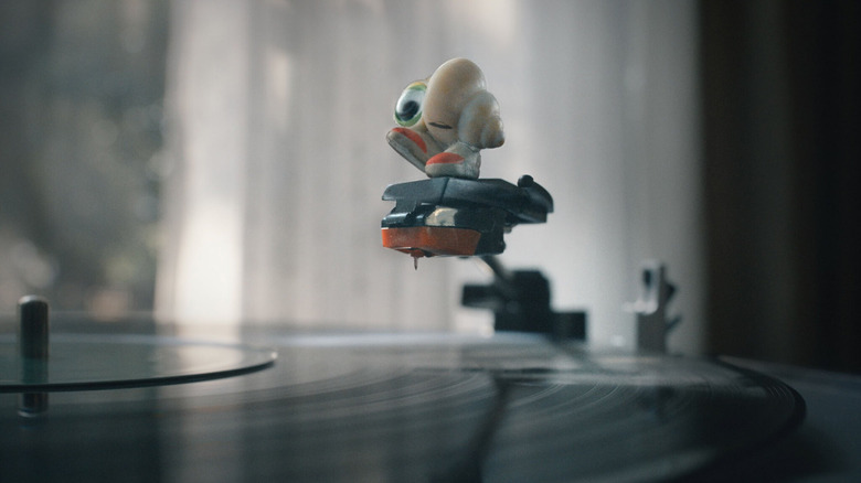 Marcel playing around with a record player in Marcel the Shell with Shoes On (2022)