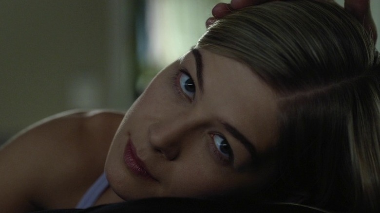 Amy looking up with a subtle, terrifying look in her eyes in Gone Girl (2014)