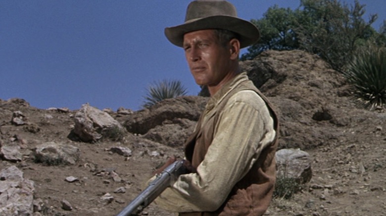 John holding a gun in the desert in Hombre