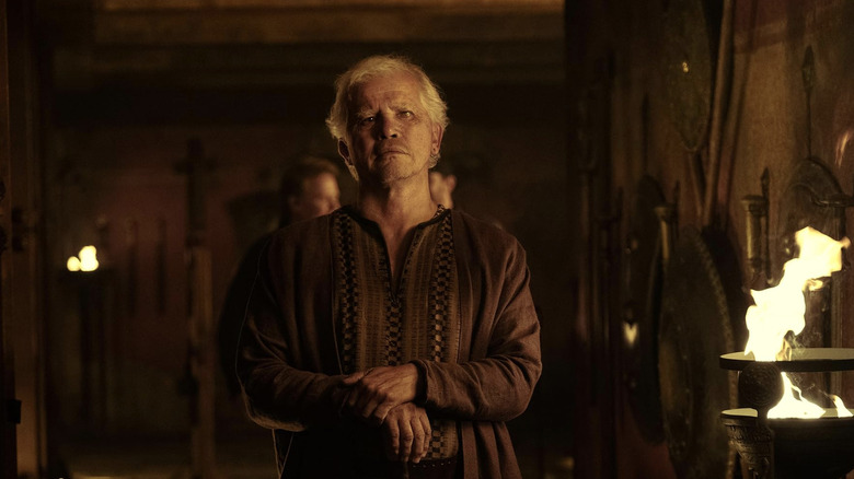 Eumaeus stands in a castle hallway in "The Odyssey" (2026)