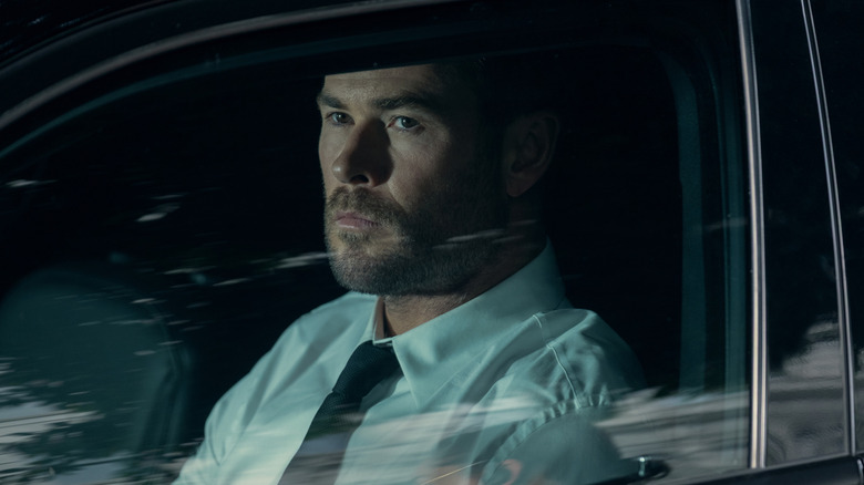 Mike Davis sitting in a car in Crime 101