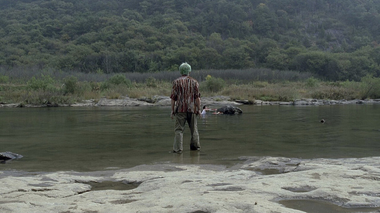 Ryu standing in a river in Sympathy for Mr. Vengeance