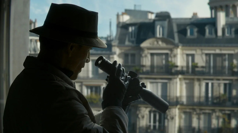The Killer looking through a telescope gun in The Killer