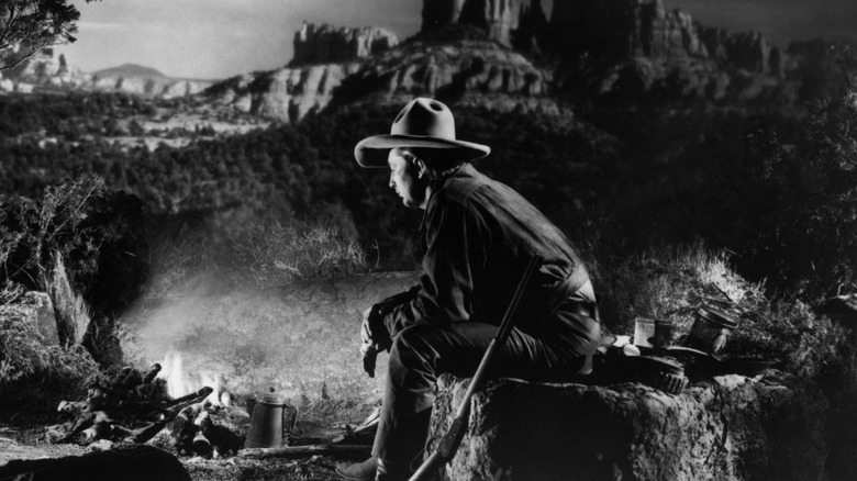 Jim Garry looking forlorn in front a crackling fire in Blood on the Moon (1948)