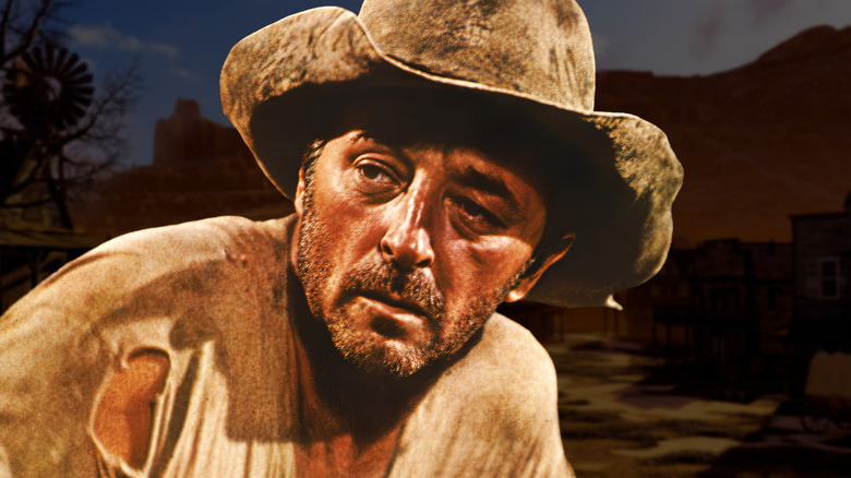 Robert Mitchum in a cowboy hat looking weary against a rural backdrop (2026)