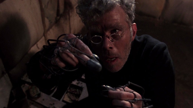 R. M. Renfield looking at a contraption in Bram Stoker's Dracula