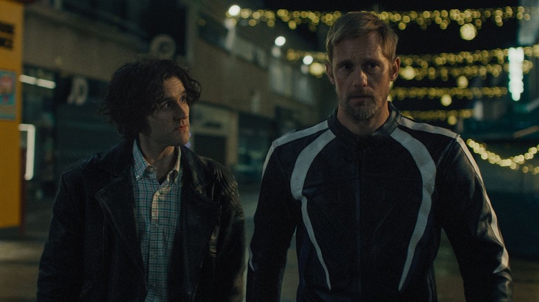 Colin and Ray walking together at night in Pillion (2026)