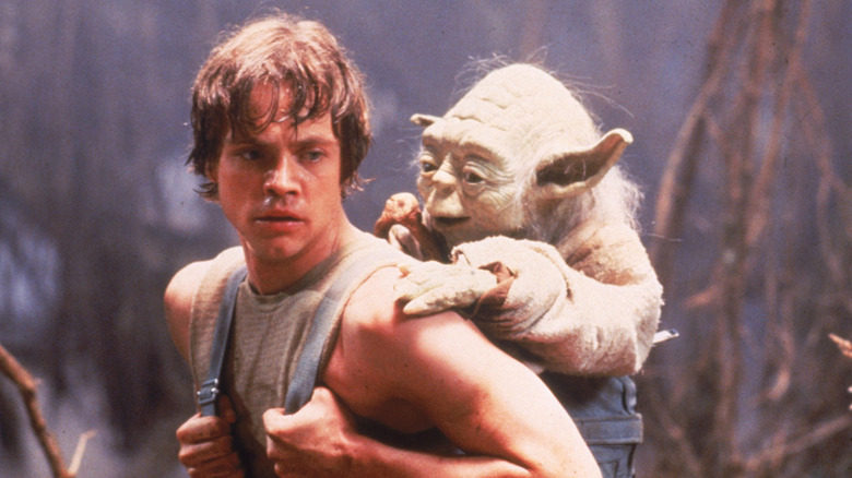 Luke carrying Yoda in a backpack through the swamps in The Empire Strikes Back