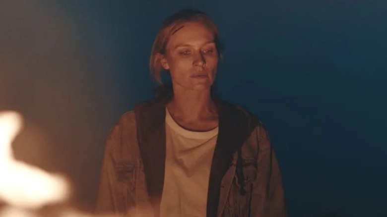 Irene Kelly looking at fire in "Redux Redux"