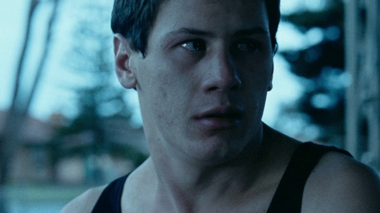 Jamie looks over his shoulder, eyes filling with tears, in "Snowtown"