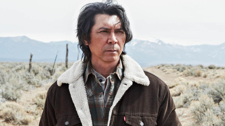 Henry Standing Bear (Lou Diamond Phillips) walking down dirt road in Longmire