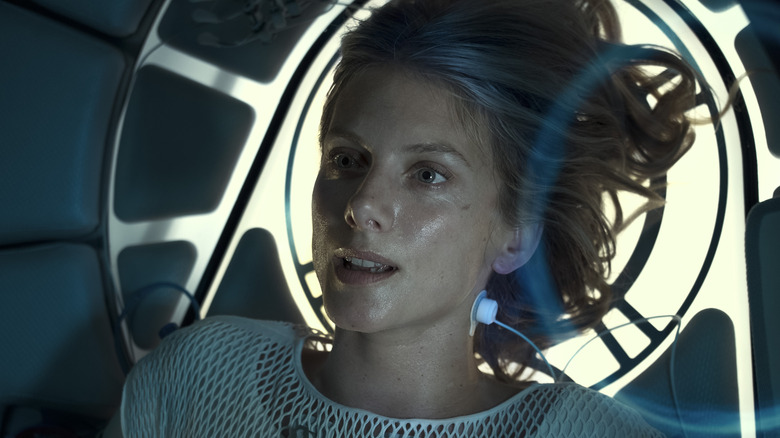 Liz Hansen hooked up on machinery and looking concerned in Oxygen (2021)