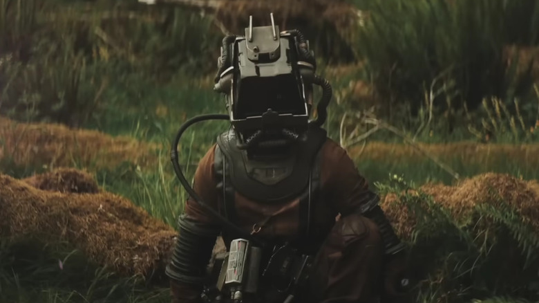 A figure wearing an ominous spacesuit in Prospect (2018)
