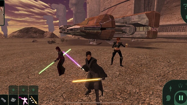 Jedi and party members standing together on an alien landscape during gameplay of Star Wars: Knights of the Old Republic (2003)