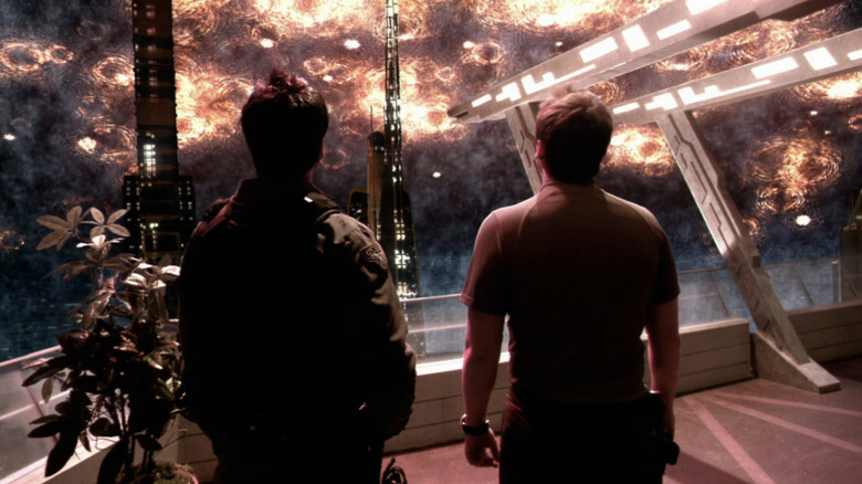 Major John Sheppard and Dr. Rodney McKay look above as Atlantis is attacked on "Stargate Atlantis" (2004-2009)