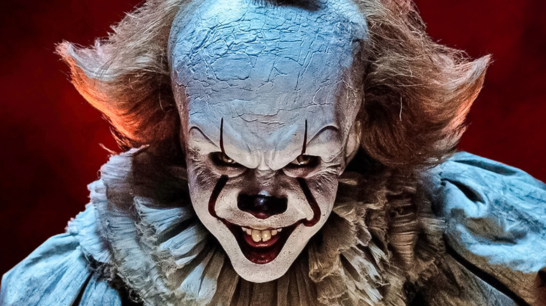Pennywise from "IT" against a red backdrop