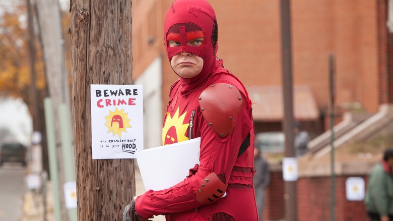 The Crimson Bolt putting up signs in "Super"