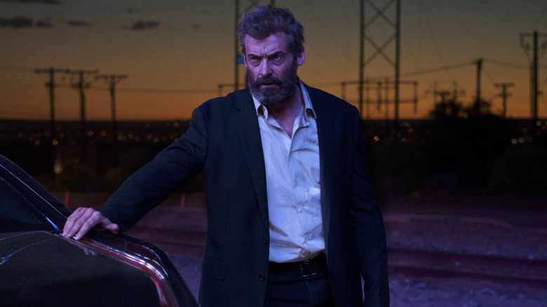 Logan touching a car in "Logan" (2017)