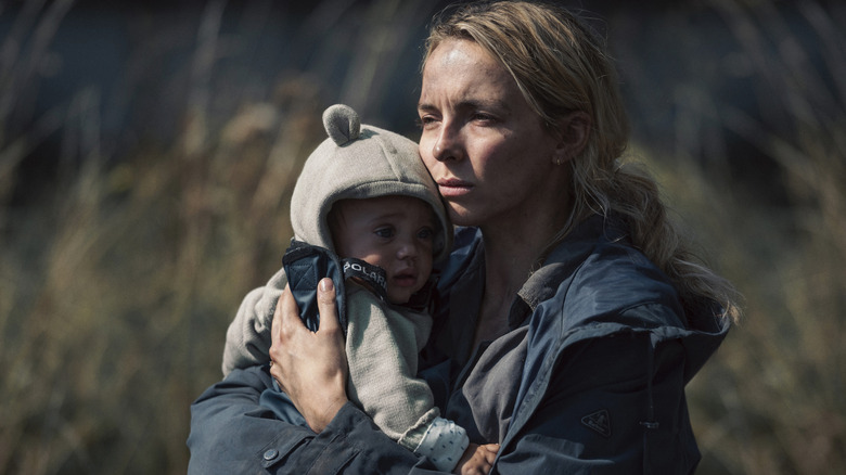 Woman holding Zeb in The End We Came From