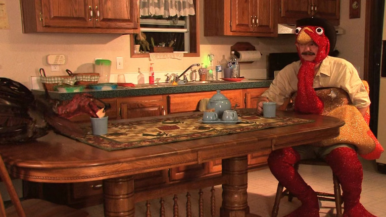 Kristen's father and Turkie at the table in "ThanksKilling" (2008)