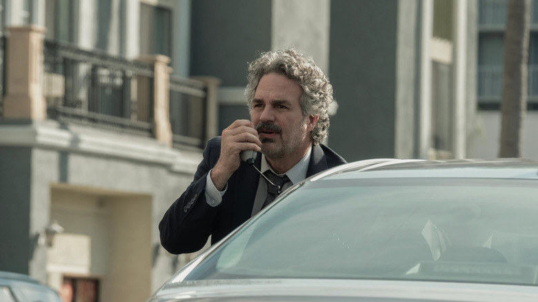 Lou talking into a radio in his car in Crime 101