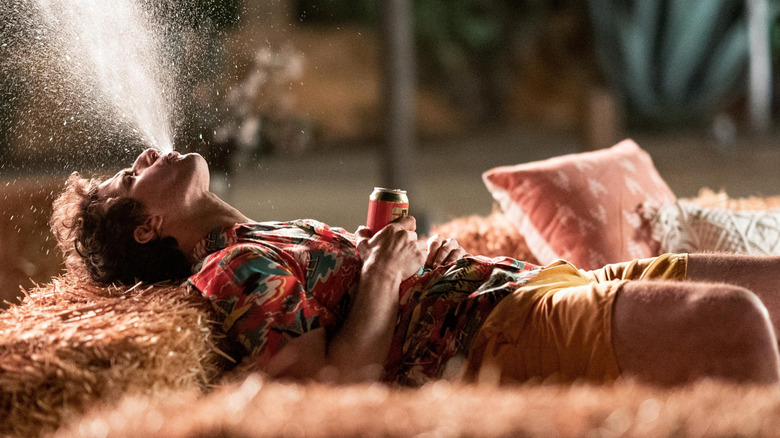 Nyles spitting up his drink in "Palm Springs" (2020)