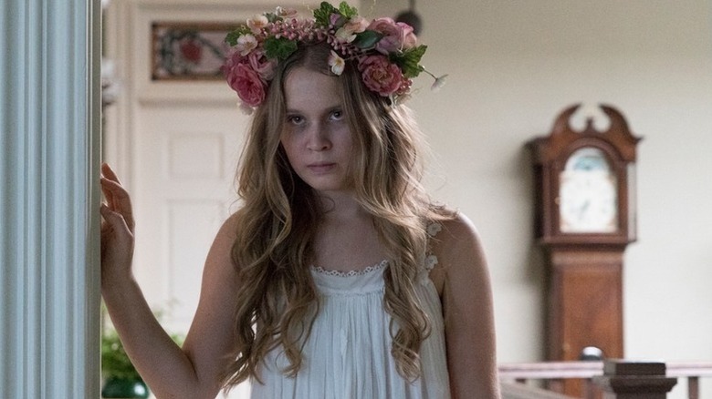 Amma wearing a flower crown with bag under her eyes in Sharp Objects