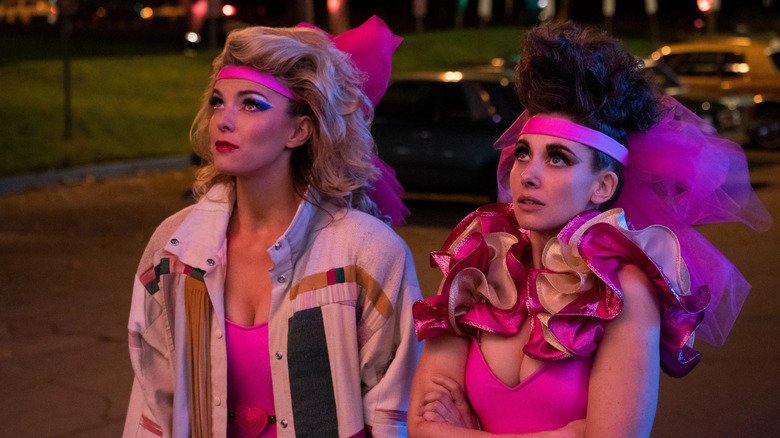 Debbie and Ruth in costume looking up at something on GLOW