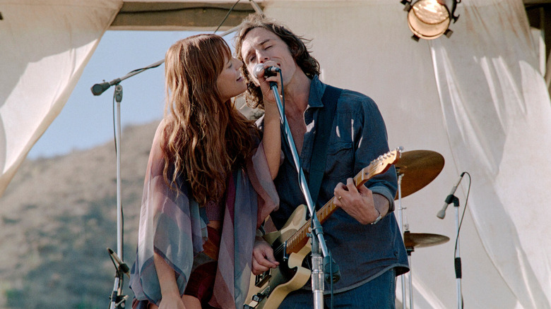 Daisy and Billy singing together at a concert in Daisy Jones and the Six