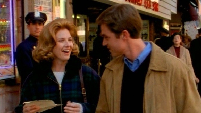 Kimberly and Johnny walking down the street smiling in Dark Skies