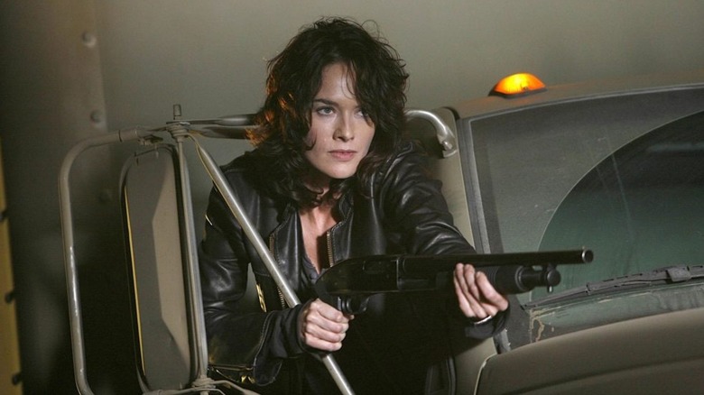 Sarah hanging out of a truck with a gun in Terminator: The Sarah Connor Chronicles