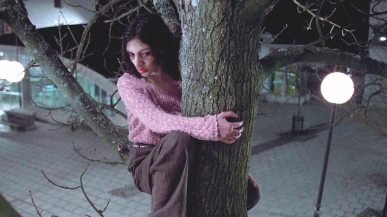 Eli hiding in a tree in "Let the Right One In"