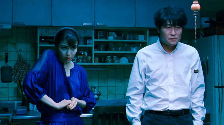 Tae-ju and Sang-hyun in her kitchen in "Thirst"