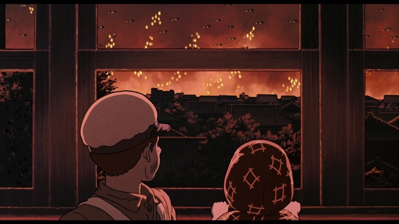 Seita and Setsuko looking out the window at air raids in Grave of the Fireflies
