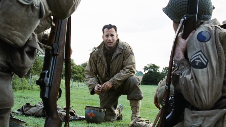 John H. Miller kneeling on the ground in Saving Private Ryan